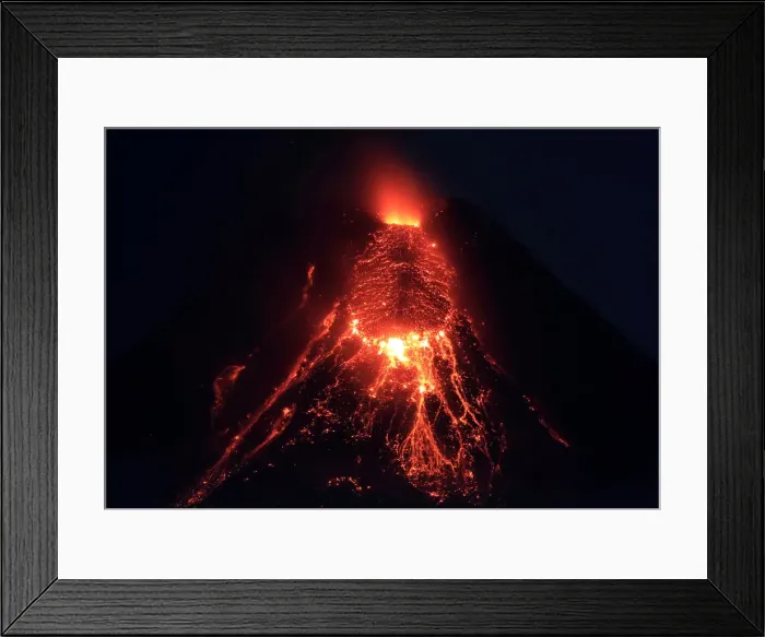 Framed Print : Lava flows from the crater of Mount Mayon Volcano during an eruption in Legazpi city