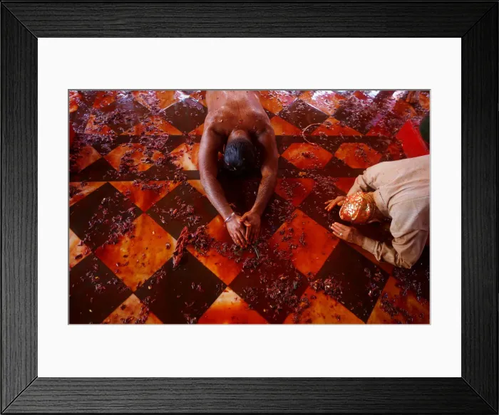 Framed Print : Hindu devotees pray during Huranga, a game played between men and women a day after Holi Framed Print : Hindu devotees pray during Huranga, a game played between men and women a day after Holi