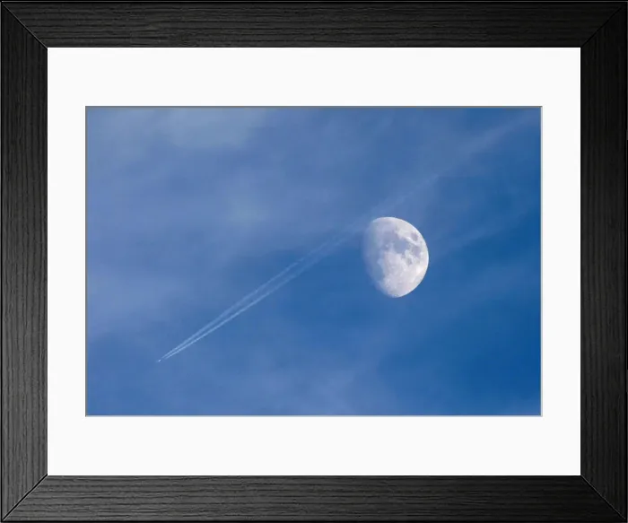 Framed Print : A passenger plane leaves a contrail as it flies past the moon over Malta Framed Print : A passenger plane leaves a contrail as it flies past the moon over Malta