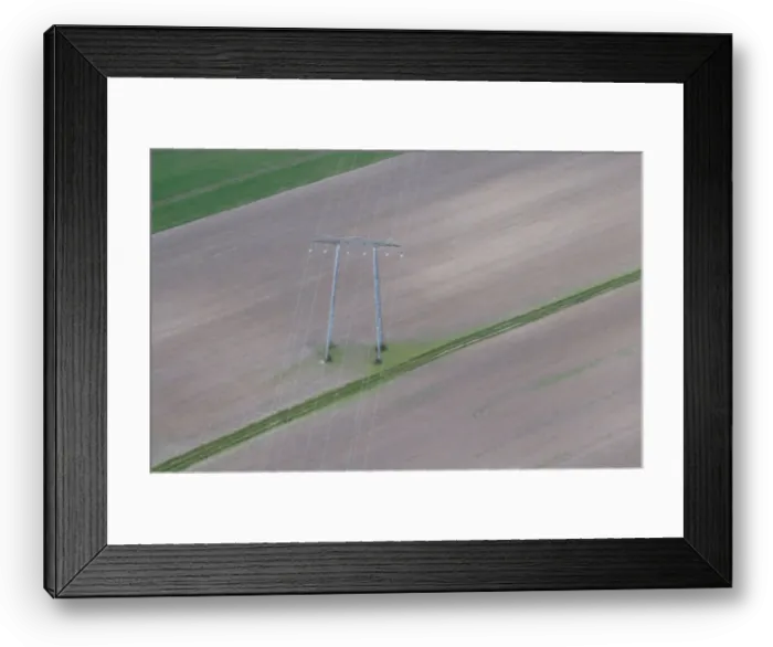 Framed Print : Aerial view shows pylon of high-tension electricity power lines in a field in Royan