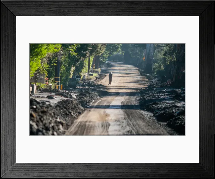 Framed Print : A man walks down East Valley Road after a mudslide in Montecito, California Framed Print : A man walks down East Valley Road after a mudslide in Montecito, California