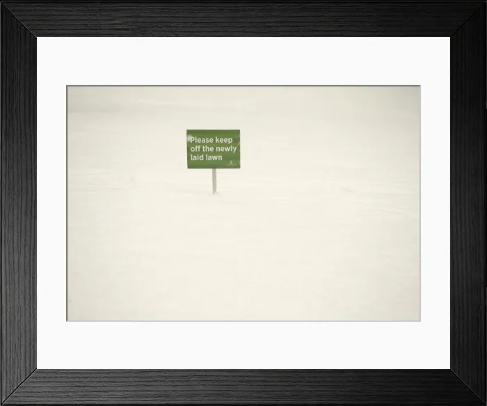 Framed Print : A sign is seen during a snow flurry in Canary Wharf, London Framed Print : A sign is seen during a snow flurry in Canary Wharf, London
