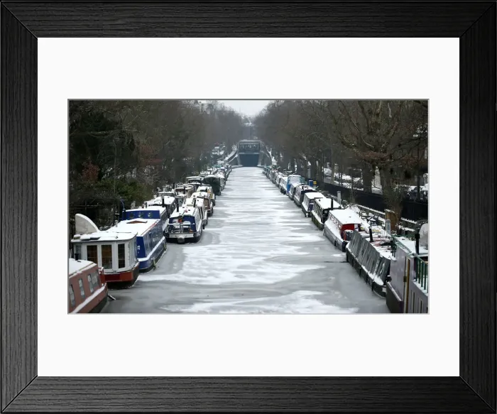 Framed Print : Canal boats are frozen at their berths on the Regents Canal in Maida Vale in London