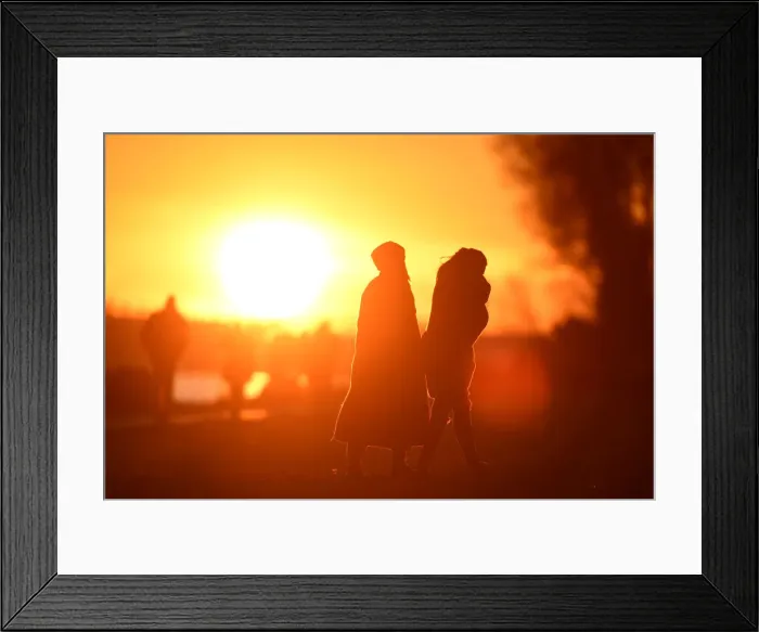 Framed Print : People enjoy the sunset at the Elbe river in Hamburg