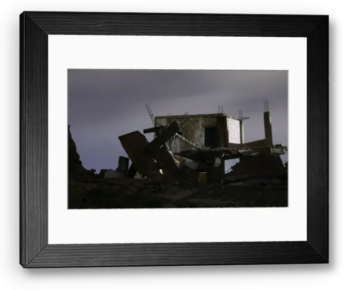Framed Print : Damaged houses are pictured at night in the rebel-held area, in the city of Daraa, Syria Framed Print : Damaged houses are pictured at night in the rebel-held area, in the city of Daraa, Syria