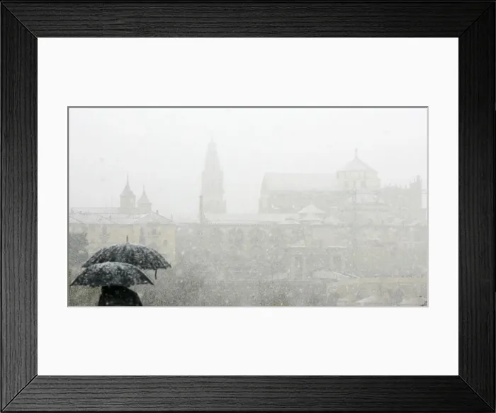 Framed Print : People stand with umbrellas in the snow, in Cordoba