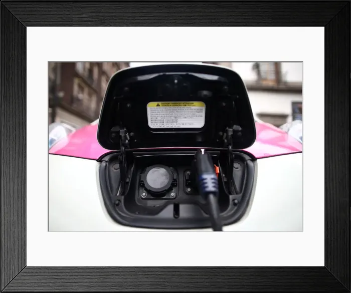 Framed Print : A car is plugged in at a charging point for electric vehicles in Mexico City Framed Print : A car is plugged in at a charging point for electric vehicles in Mexico City