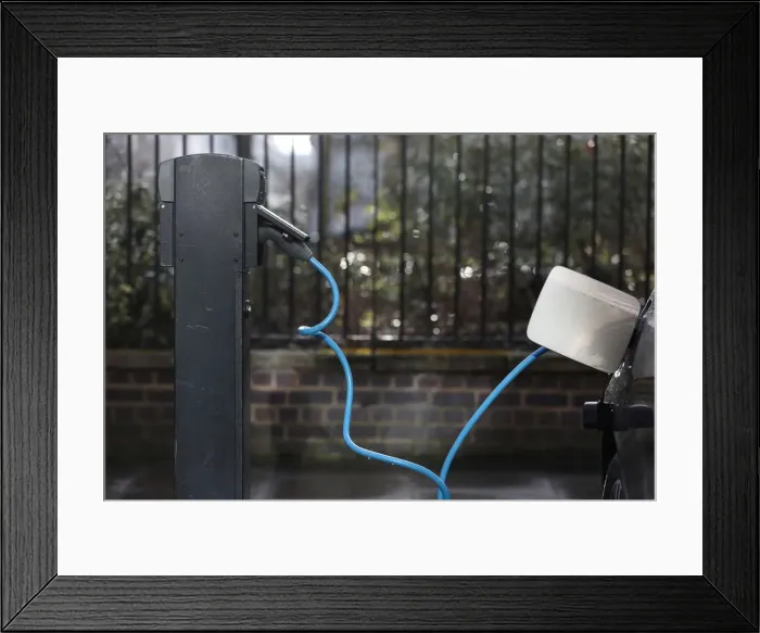 Framed Print : A car is plugged in at a charging point for electric vehicles in London Framed Print : A car is plugged in at a charging point for electric vehicles in London