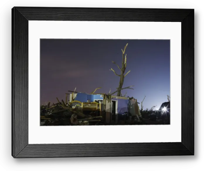 Framed Print : The evening light illuminates a childs bed in a destroyed home Framed Print : The evening light illuminates a childs bed in a destroyed home