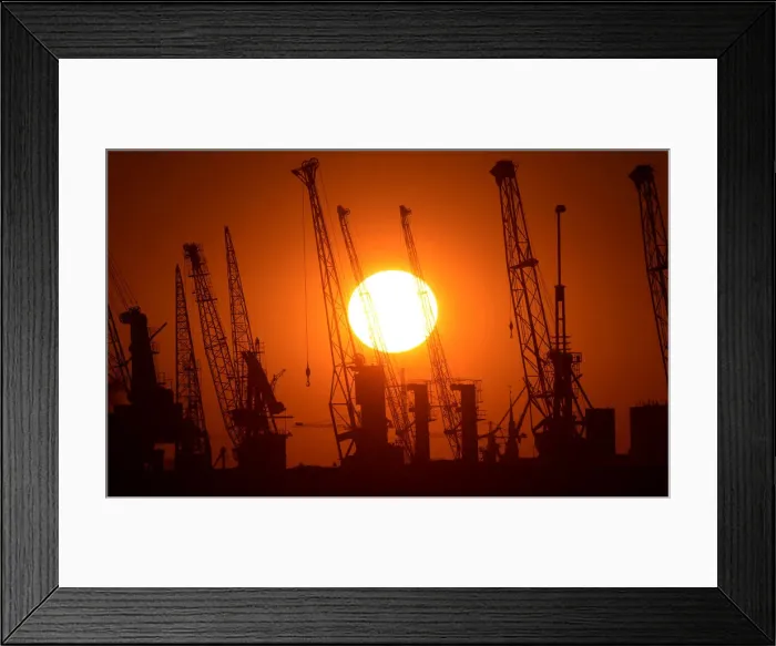 Framed Print : Cranes of German shipyard Blohm&Voss are silhouetted during sunset in Hamburg Framed Print : Cranes of German shipyard Blohm&Voss are silhouetted during sunset in Hamburg