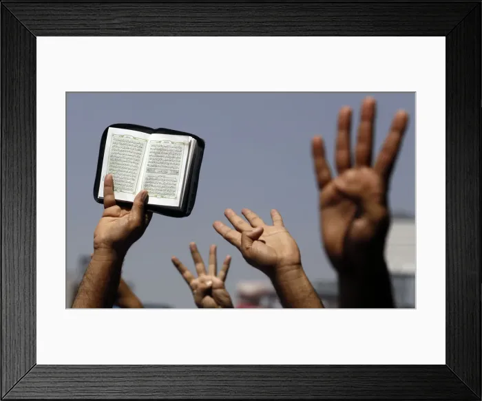 Framed Print : Supporters of Muslim Brotherhood and ousted Egyptian President Mursi hold up a Koran Framed Print : Supporters of Muslim Brotherhood and ousted Egyptian President Mursi hold up a Koran