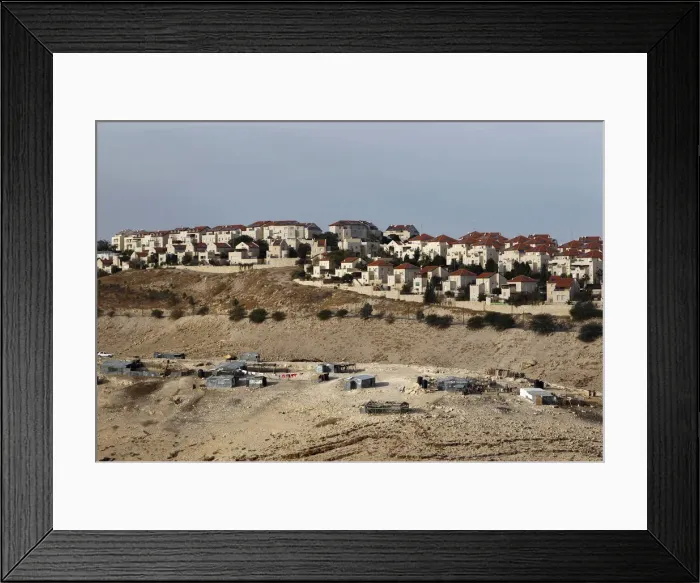 Framed Print : A Bedouin encampment of the Jahalin tribe is seen in front of the Jewish settlement of