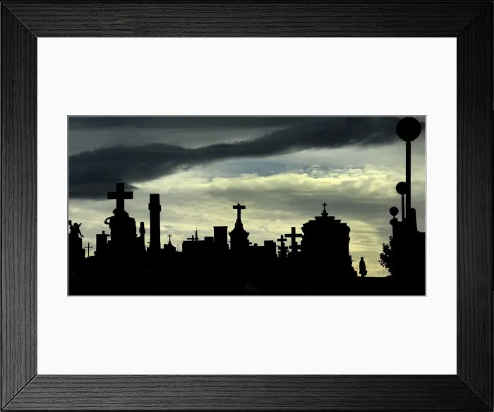 Framed Print : A woman walks along the tombs at the municipal cemetery of San Salvador in Oviedo Framed Print : A woman walks along the tombs at the municipal cemetery of San Salvador in Oviedo
