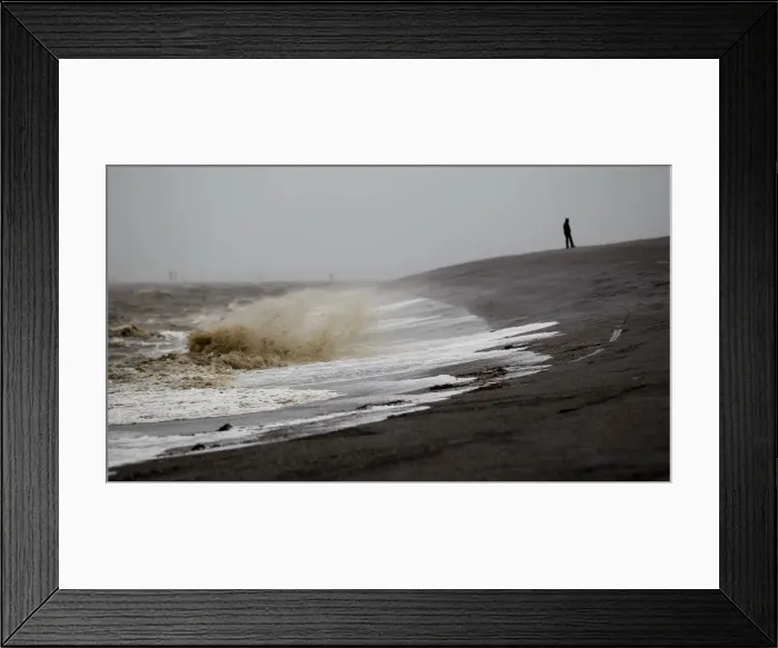 Framed Print : A man walks on the North Sea beach near the town of Norddeich Framed Print : A man walks on the North Sea beach near the town of Norddeich