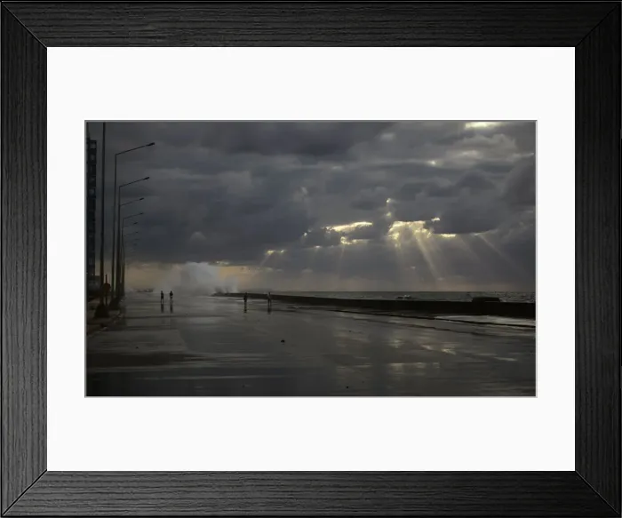 Framed Print : People walk as waves crash on the El Malecon seafront boulevard Framed Print : People walk as waves crash on the El Malecon seafront boulevard
