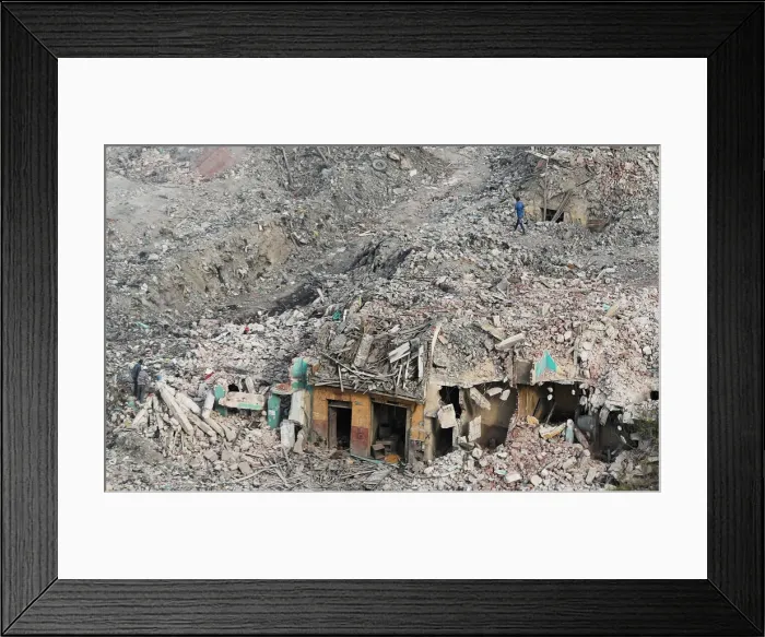 Framed Print : People are seen walking near the now-demolished buildings of the Maspero Triangle slum Framed Print : People are seen walking near the now-demolished buildings of the Maspero Triangle slum