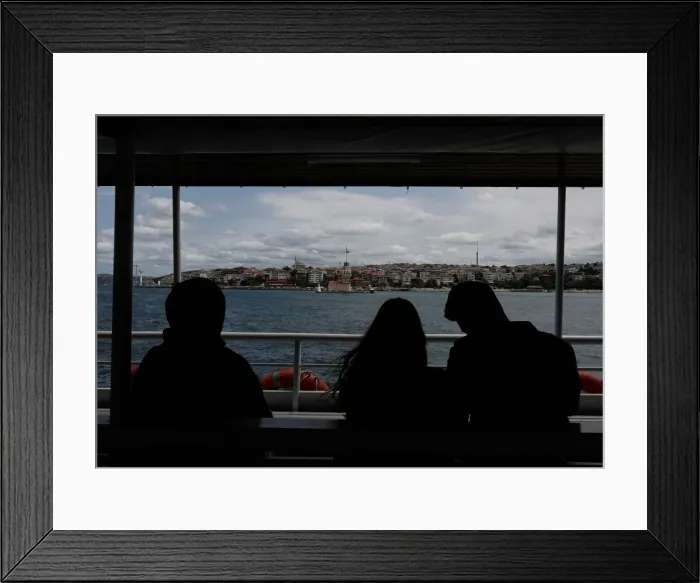 Framed Print : People travel on a ferry over the Bosphorus in Istanbul