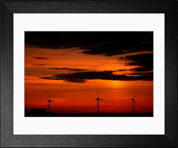 Framed Print : Power-generating windmill turbines are pictured during sunset at a wind park in Framed Print : Power-generating windmill turbines are pictured during sunset at a wind park in