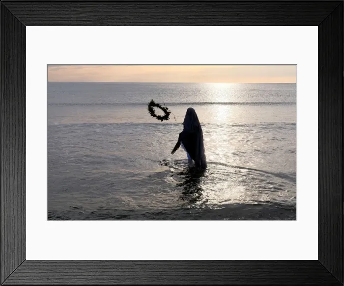 Framed Print : A woman throws a wreath into the water during a procession of the Santisimo Cristo del Framed Print : A woman throws a wreath into the water during a procession of the Santisimo Cristo del
