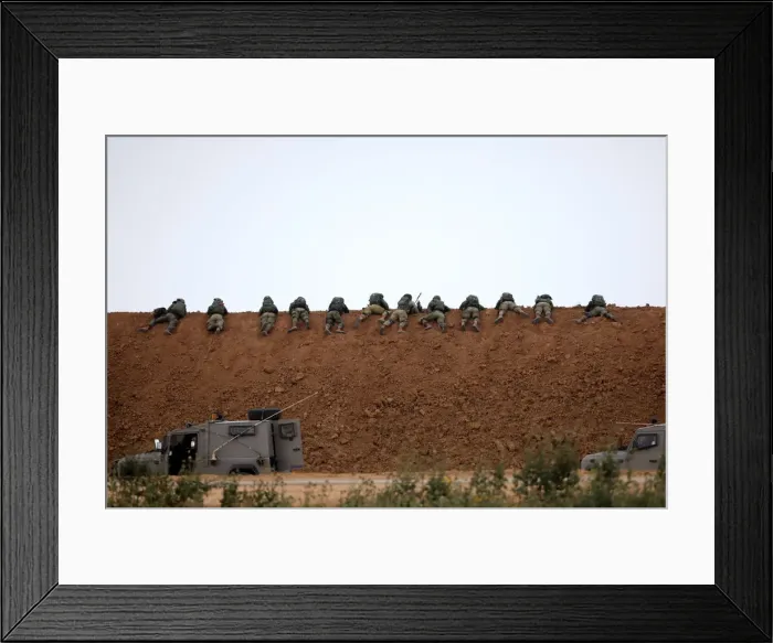Framed Print : Israeli soldiers are seen next to the border fence on the Israeli side of the border with Framed Print : Israeli soldiers are seen next to the border fence on the Israeli side of the border with