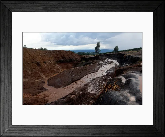 Framed Print : A general view shows water flowing from the dam that burst its walls Framed Print : A general view shows water flowing from the dam that burst its walls