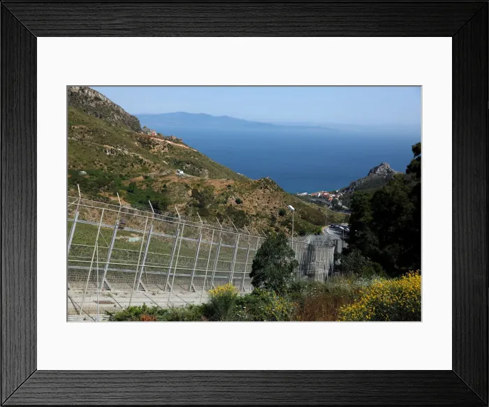 Framed Print : The border fence separating Spains northern enclave Ceuta and Morocco is seen from Ceuta Framed Print : The border fence separating Spains northern enclave Ceuta and Morocco is seen from Ceuta