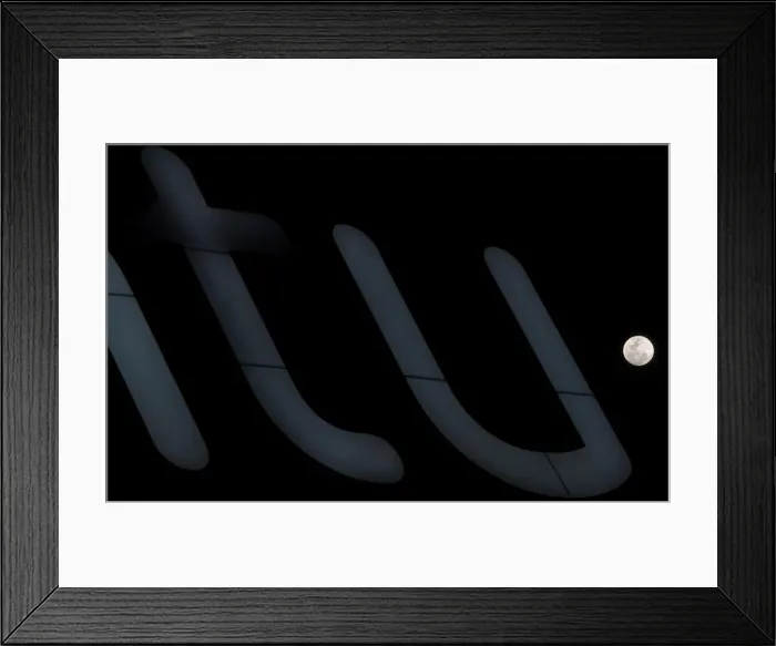 Framed Print : A full moon super moon is seen behind a luminous sign in Siero