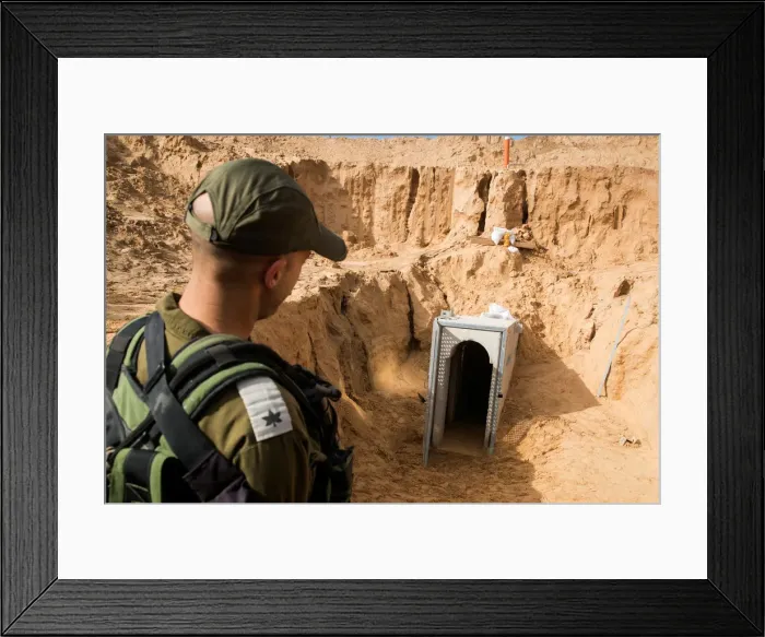 Framed Print : An Israeli soldier stands next to an entrance to what the Israeli military say is a Framed Print : An Israeli soldier stands next to an entrance to what the Israeli military say is a