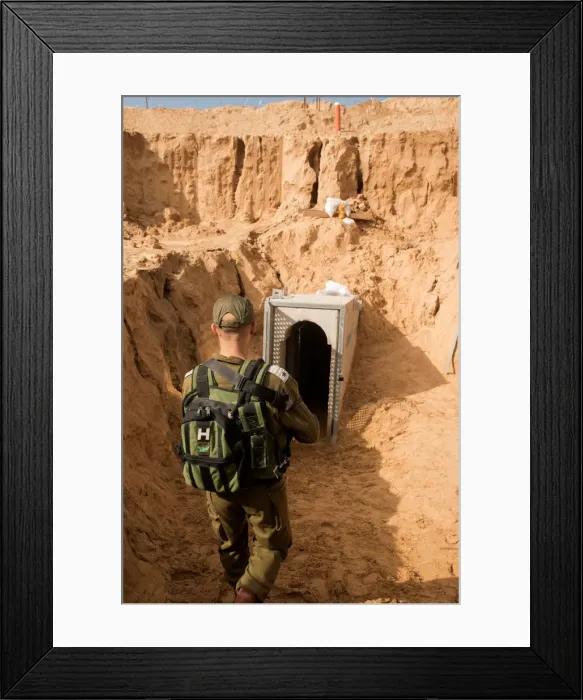 Framed Print : An Israeli soldier stands next to an entrance to what the Israeli military say is a Framed Print : An Israeli soldier stands next to an entrance to what the Israeli military say is a