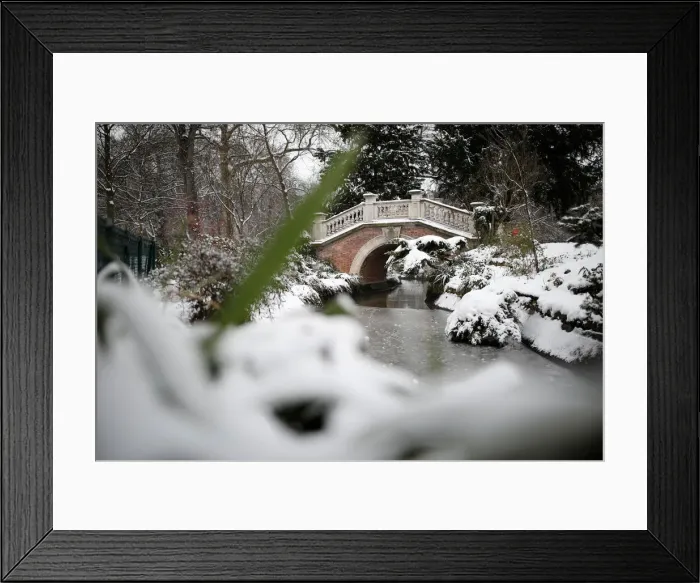Framed Print : A view shows a bridge in the Parc Monceau as winter weather bringing snow Framed Print : A view shows a bridge in the Parc Monceau as winter weather bringing snow
