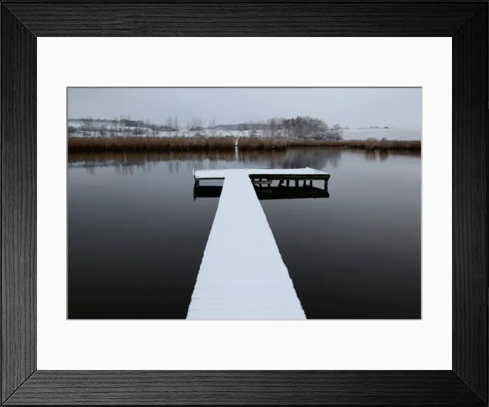 Framed Print : Snow covered pier is seen on a lake near the village of Etyek Framed Print : Snow covered pier is seen on a lake near the village of Etyek