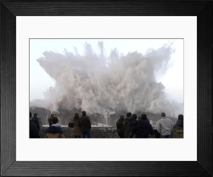 Framed Print : People look and take pictures of giant waves in the port town of Llanes