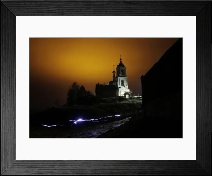 Framed Print : A man uses a torch as he leaves a church after an Orthodox Easter night mass in Framed Print : A man uses a torch as he leaves a church after an Orthodox Easter night mass in