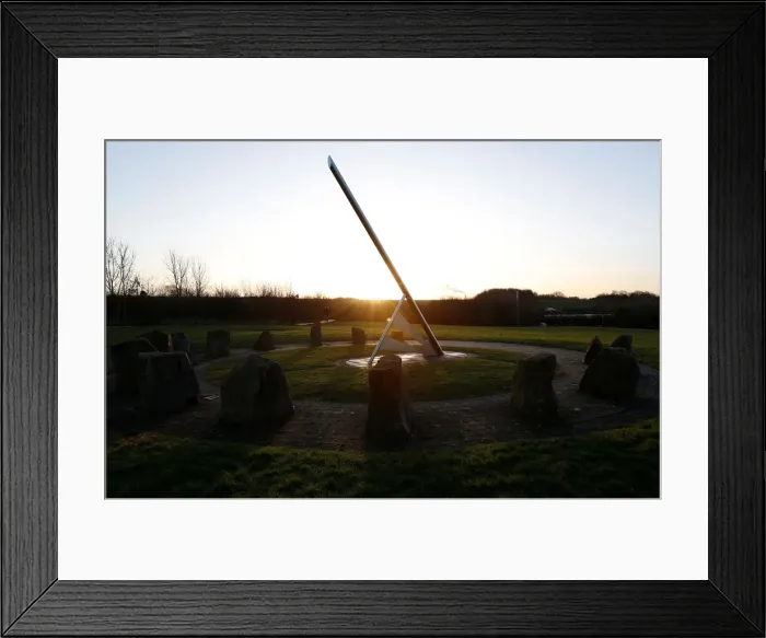 Framed Print : A man walks his dog past the Millennium Sundial in Barrow upon Soar Framed Print : A man walks his dog past the Millennium Sundial in Barrow upon Soar