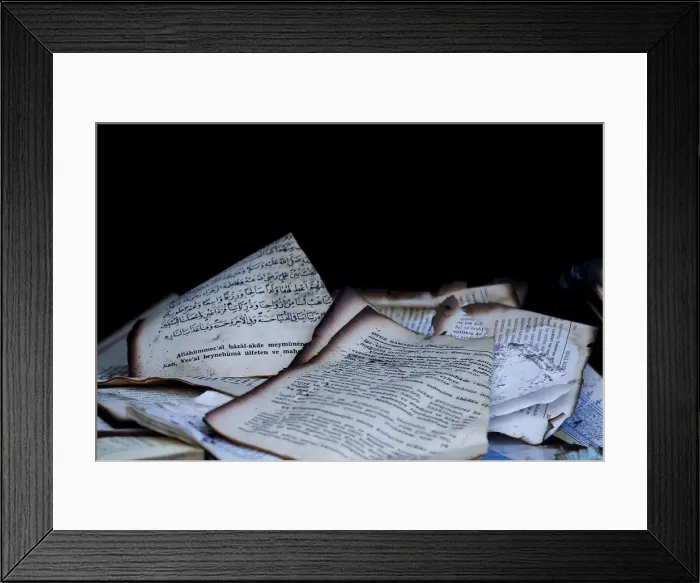 Framed Print : Damaged books are pictured in a mosque after it was destroyed by a fire in Berlin