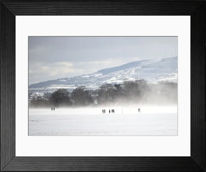 Framed Print : People run on a football field in the snow at the Phoenix Park in Dublin Framed Print : People run on a football field in the snow at the Phoenix Park in Dublin