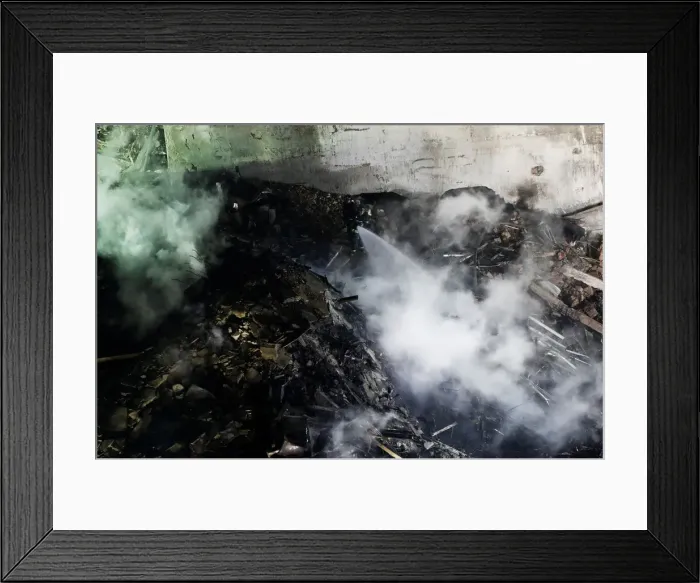 Framed Print : Firefighters try to extinguish a fire at a building that caught fire Framed Print : Firefighters try to extinguish a fire at a building that caught fire