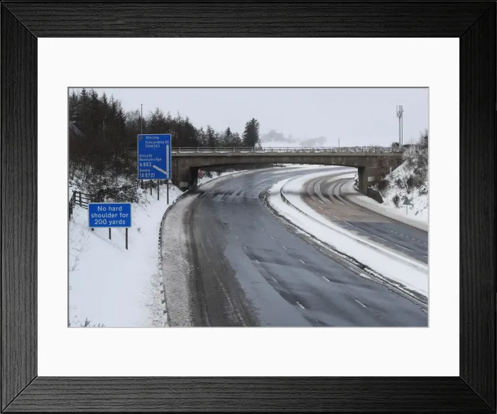 Framed Print : The M80 motorway is completely empty after being closed to clear vehicles stranded by bad Framed Print : The M80 motorway is completely empty after being closed to clear vehicles stranded by bad