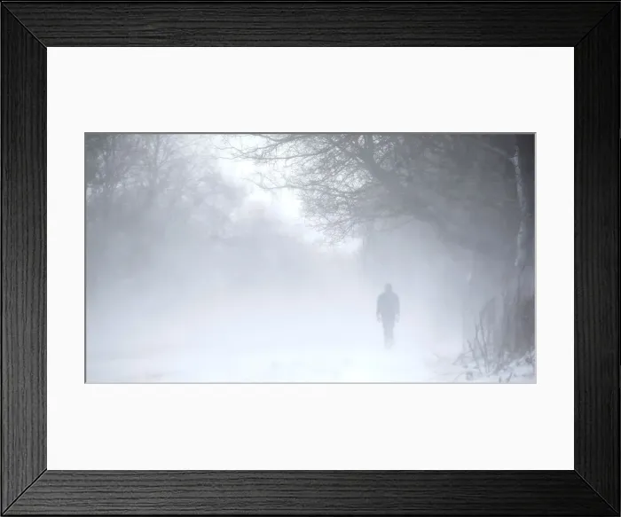 Framed Print : A man walks along the A53 Buxton Road which is closed due to heavy snow fall, near Leek Framed Print : A man walks along the A53 Buxton Road which is closed due to heavy snow fall, near Leek