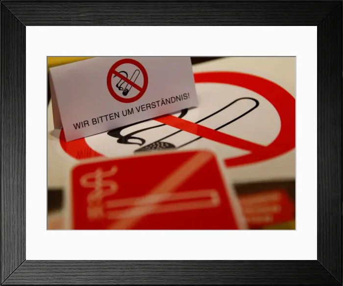 Framed Print : No smoking signs are seen on a table in a sign shop in Vienna Framed Print : No smoking signs are seen on a table in a sign shop in Vienna