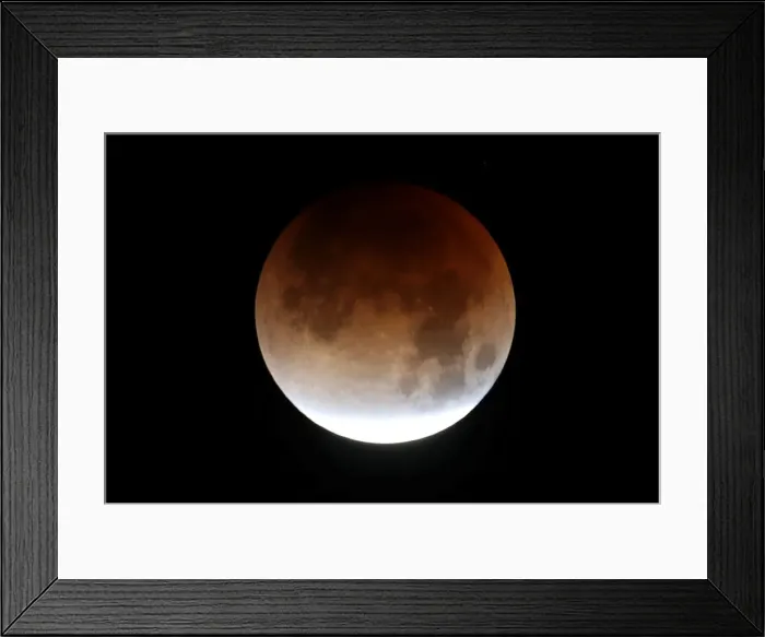 Framed Print : A lunar eclipse of a full Blue Moon is seen in Santa Monica Framed Print : A lunar eclipse of a full Blue Moon is seen in Santa Monica