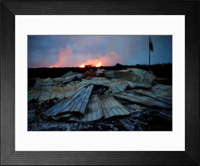 Framed Print : As a lava fissure erupts in the distance, a destroyed structure is seen in the Leilani Framed Print : As a lava fissure erupts in the distance, a destroyed structure is seen in the Leilani
