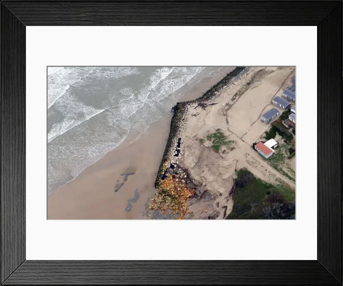 Framed Print : An aerial view shows sea walls on the beach that protect camping Framed Print : An aerial view shows sea walls on the beach that protect camping