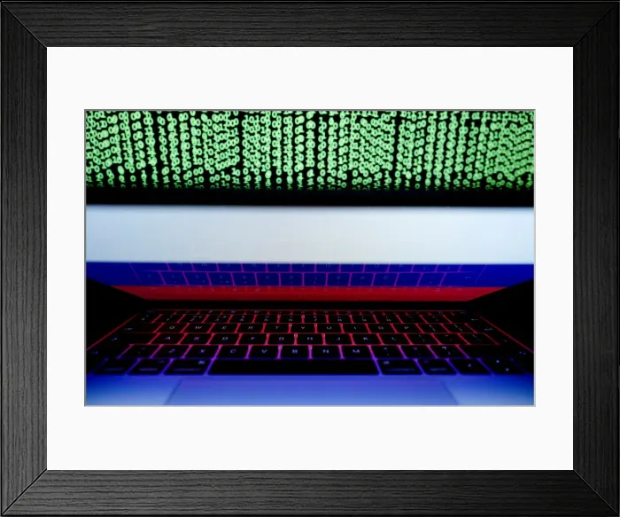 Framed Print : Russian flag is seen on the laptop screen in front of a computer screen on which cyber Framed Print : Russian flag is seen on the laptop screen in front of a computer screen on which cyber