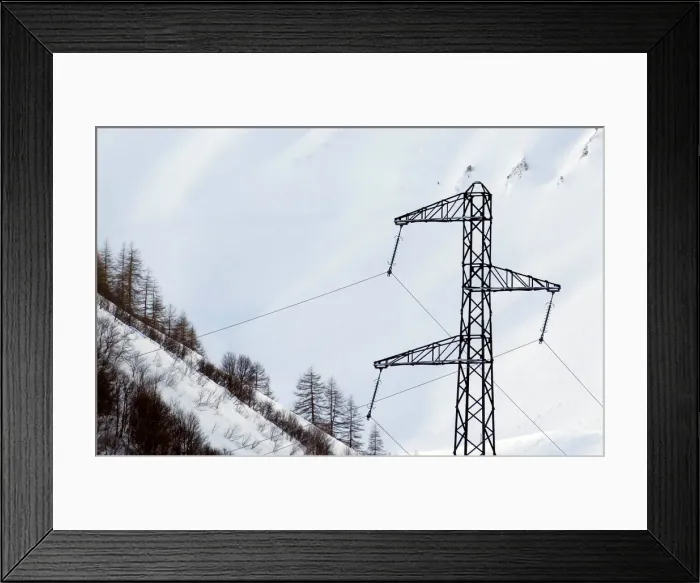 Framed Print : Pylon of high-tension electricity power lines is pictured on snow-covered mountain in Framed Print : Pylon of high-tension electricity power lines is pictured on snow-covered mountain in