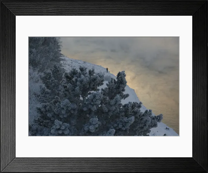 Framed Print : A fisherman is seen on a bank of the Yenisei River at sunset near the Krasnoyarsk hydro