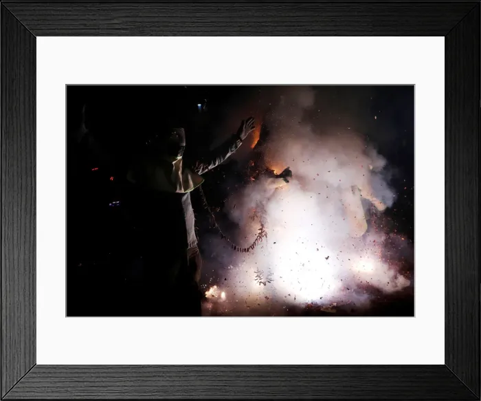 Framed Print : Participants wearing motorcycle helmets get sprayed with firecrackers Framed Print : Participants wearing motorcycle helmets get sprayed with firecrackers
