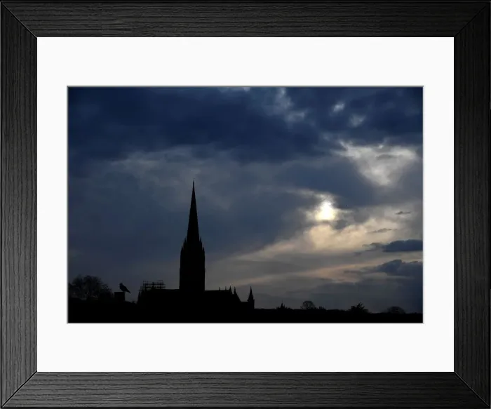 Framed Print : The afternoon sun pierces clouds behind Salisbury Cathedral