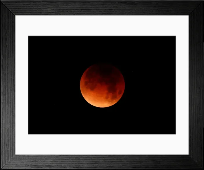 Framed Print : A lunar eclipse is shown over the ocean in Oceanside, California Framed Print : A lunar eclipse is shown over the ocean in Oceanside, California