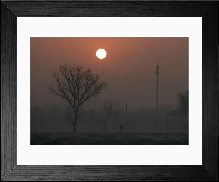 Framed Print : A man walks during sunrise in smog as a red alert issued for air pollution in Beijing